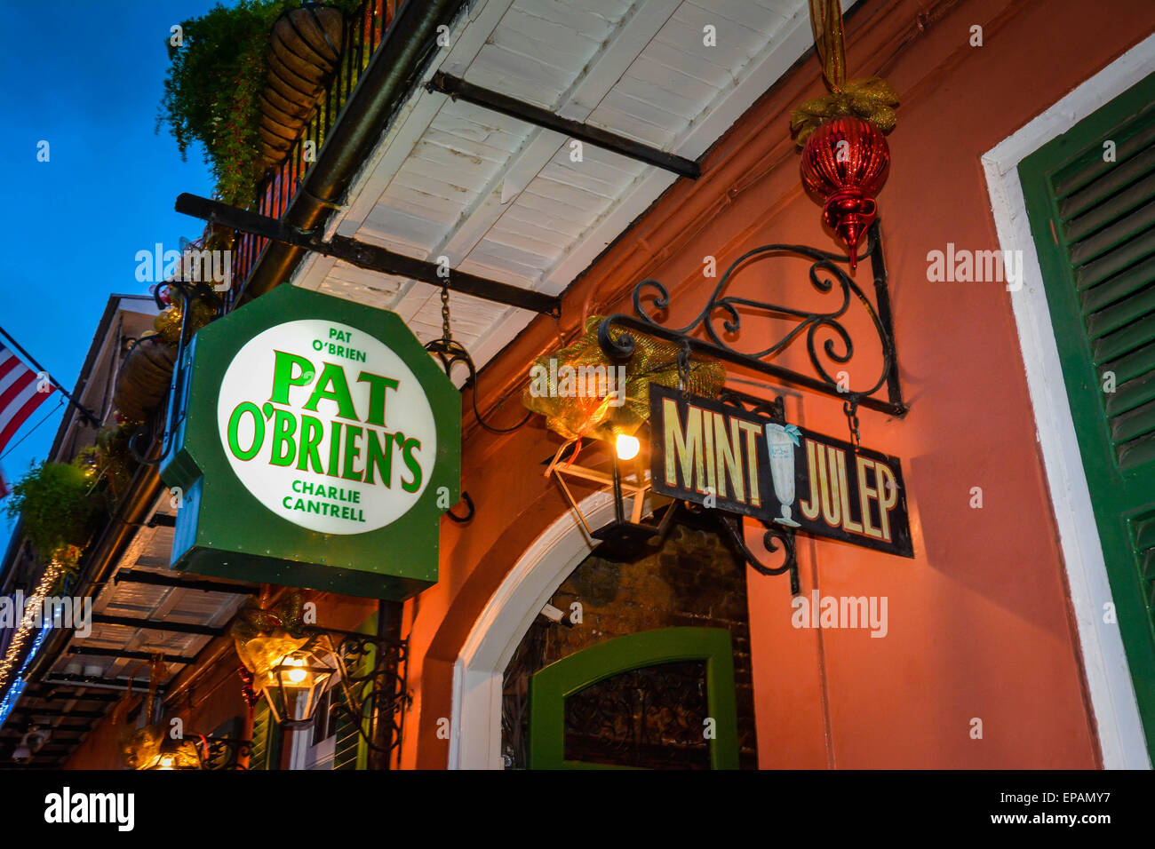 Overhead signs outside the famous, Pat O'Brien's Tavern at dusk, famous for their legendary cocktail, the 'Hurricane', French Quarter, New Orleans, LA Stock Photo