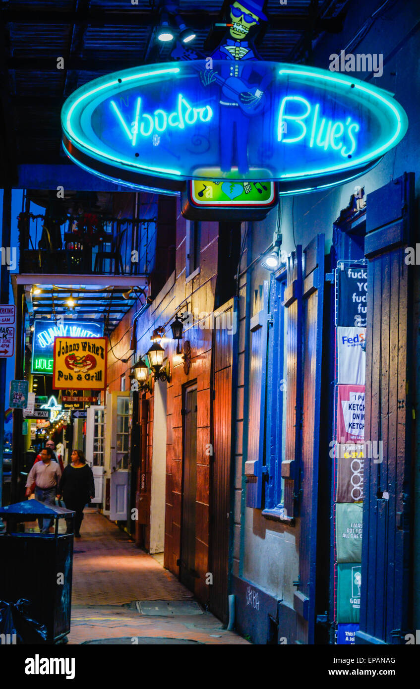 A night image of The Voodoo Blues shop's neon sign on Bourbon Street in the French Quarter, New Orleans, LA Stock Photo