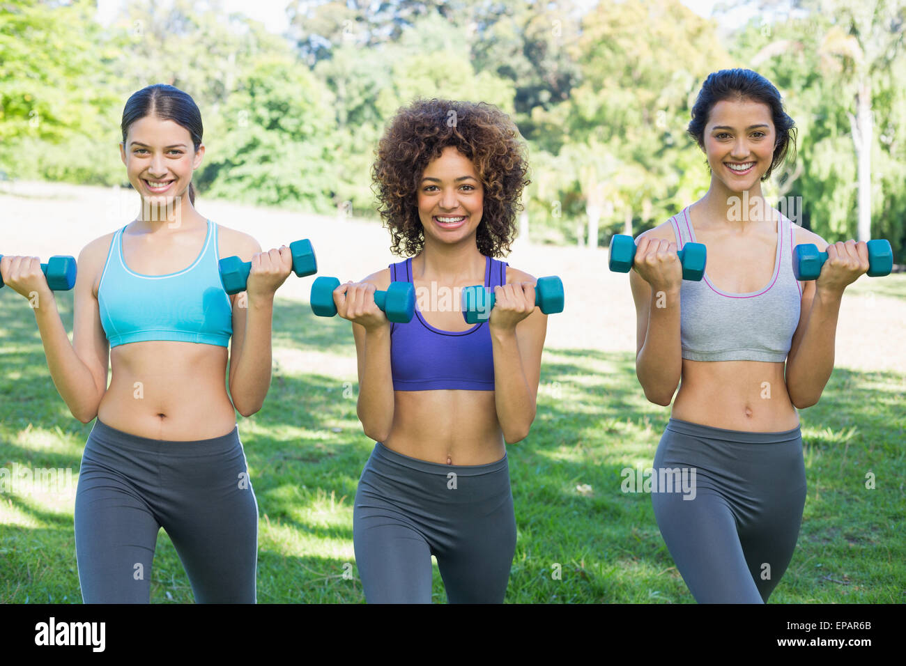 Female friends lifting dumbbells Stock Photo Alamy
