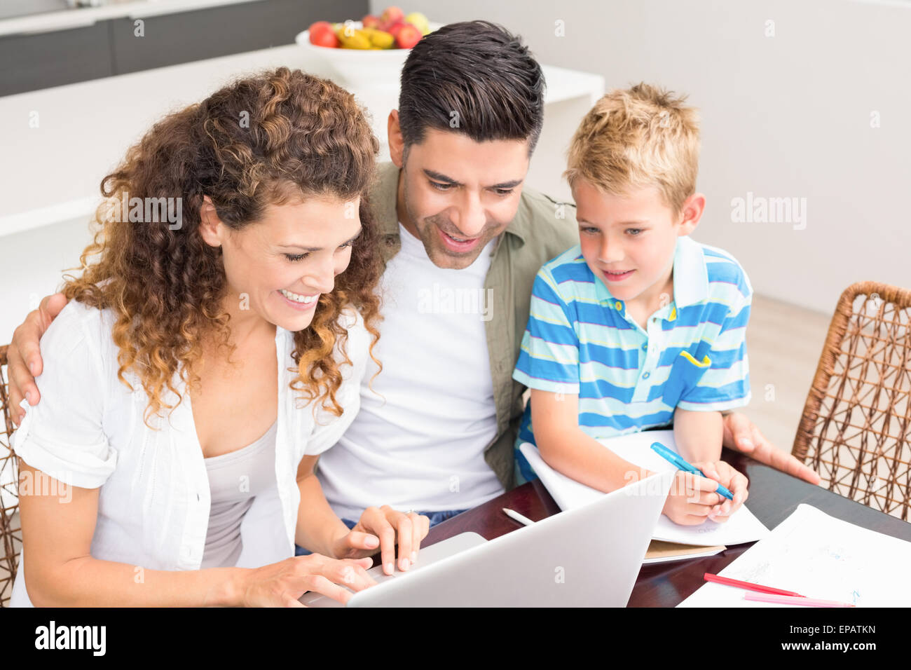 Cute little boy using laptop with his parents at table Stock Photo - Alamy