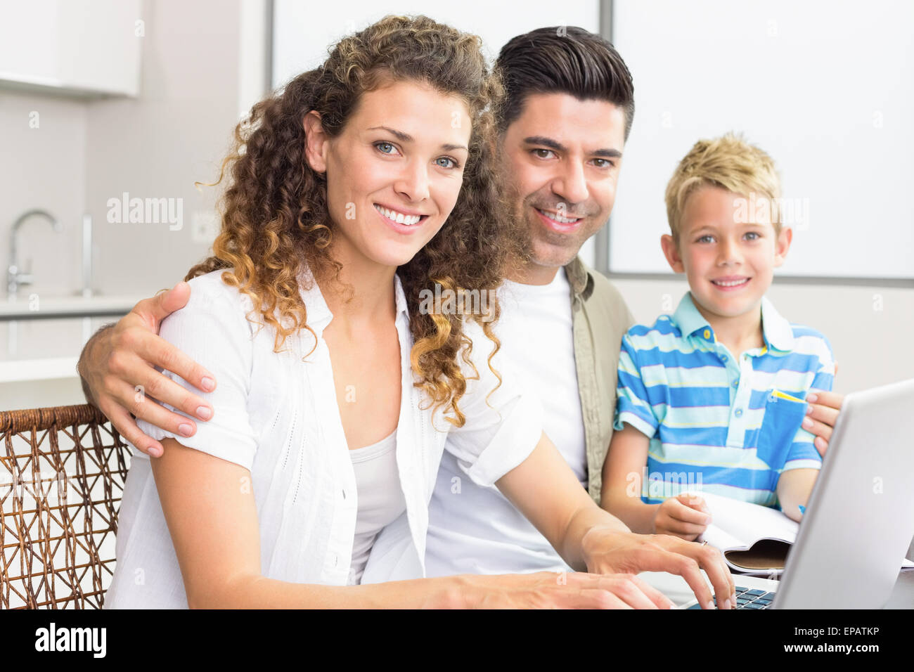 Cute little boy using laptop with parents at table Stock Photo - Alamy