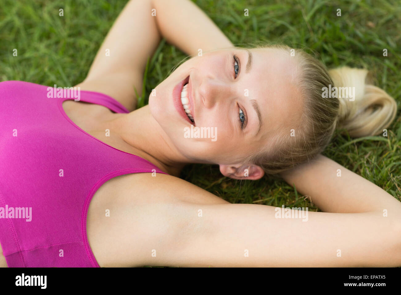 Relaxed beautiful woman lying on grass in park Stock Photo - Alamy