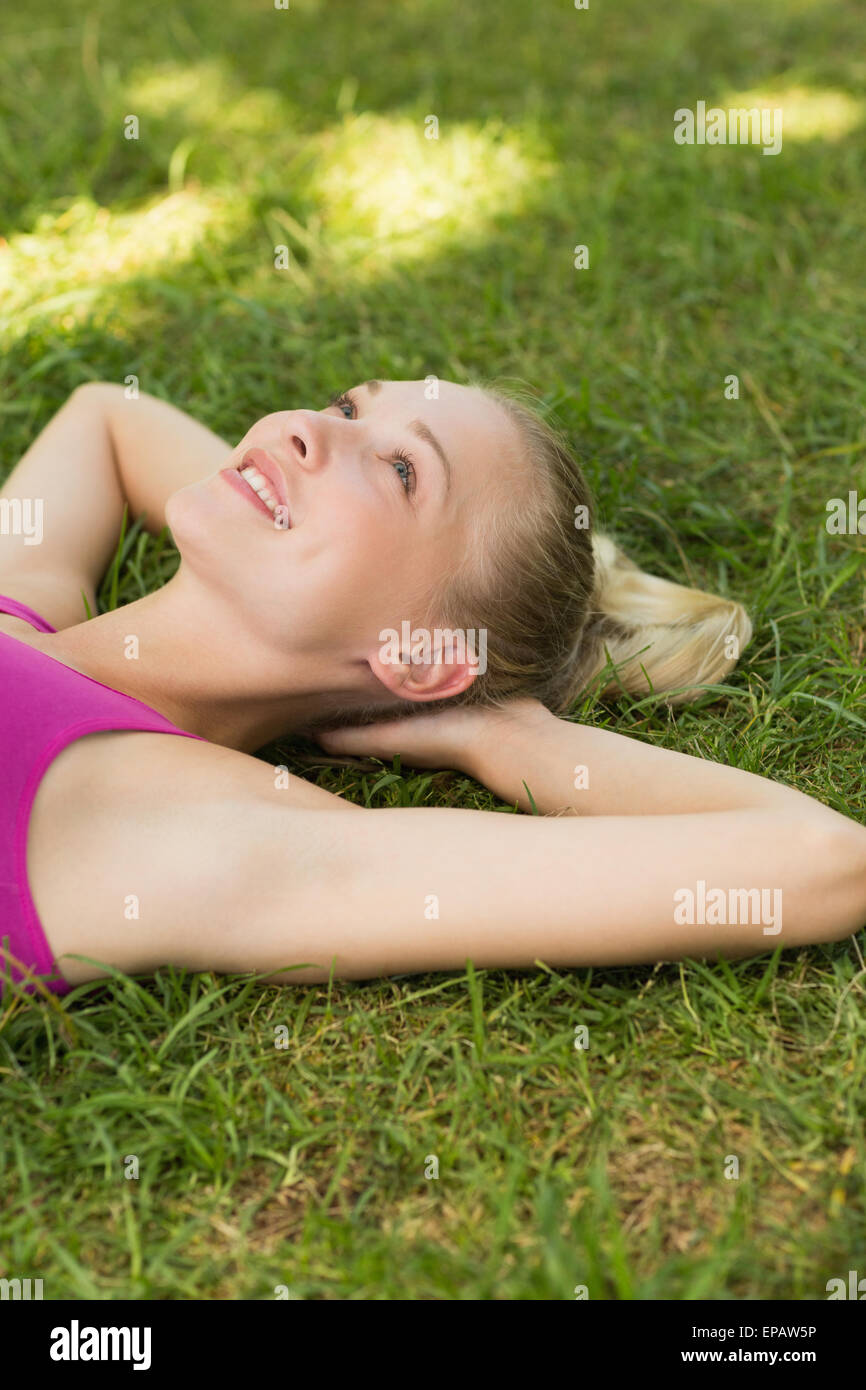 Relaxed beautiful woman lying on grass in park Stock Photo - Alamy