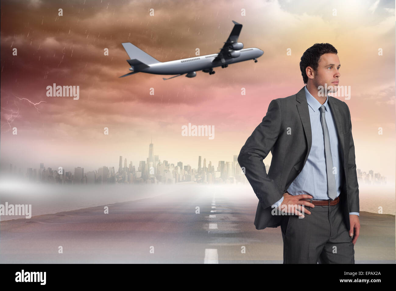 Composite image of businessman with hand on hip Stock Photo