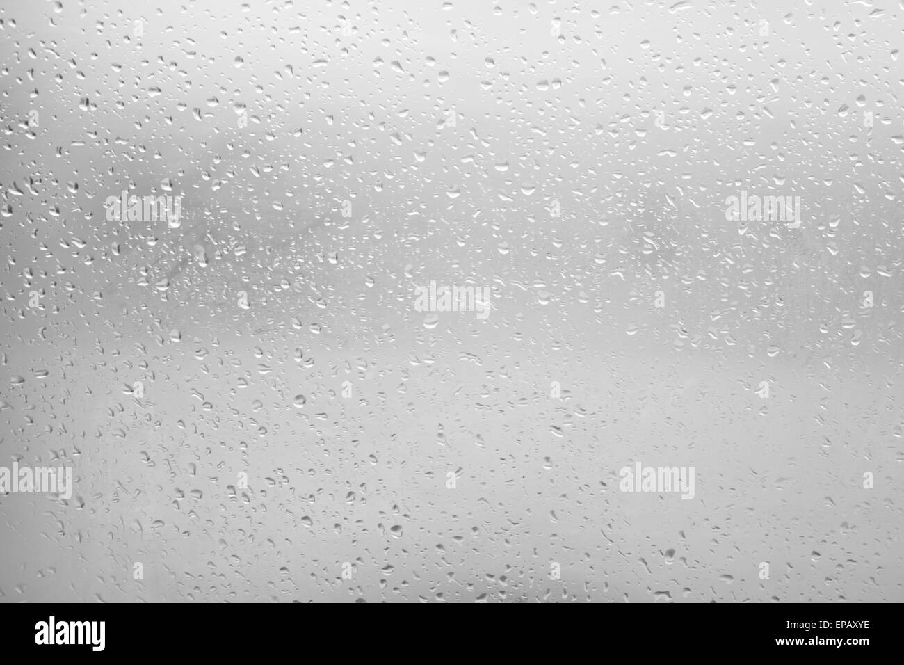 Flowing water drops on the glass in a gloomy autumn day Stock Photo - Alamy