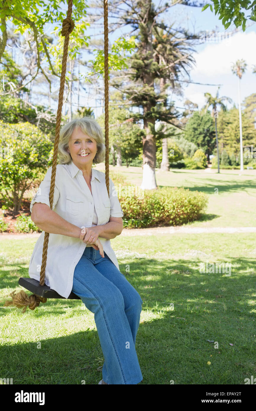 Mature woman sitting on swing hi-res stock photography and images - Alamy