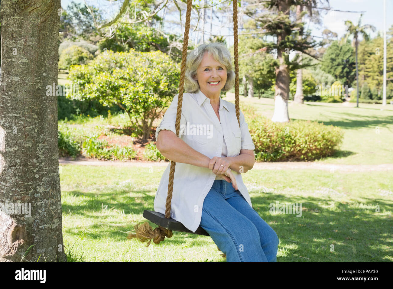 Mature woman swinging in park hi-res stock photography and images - Alamy