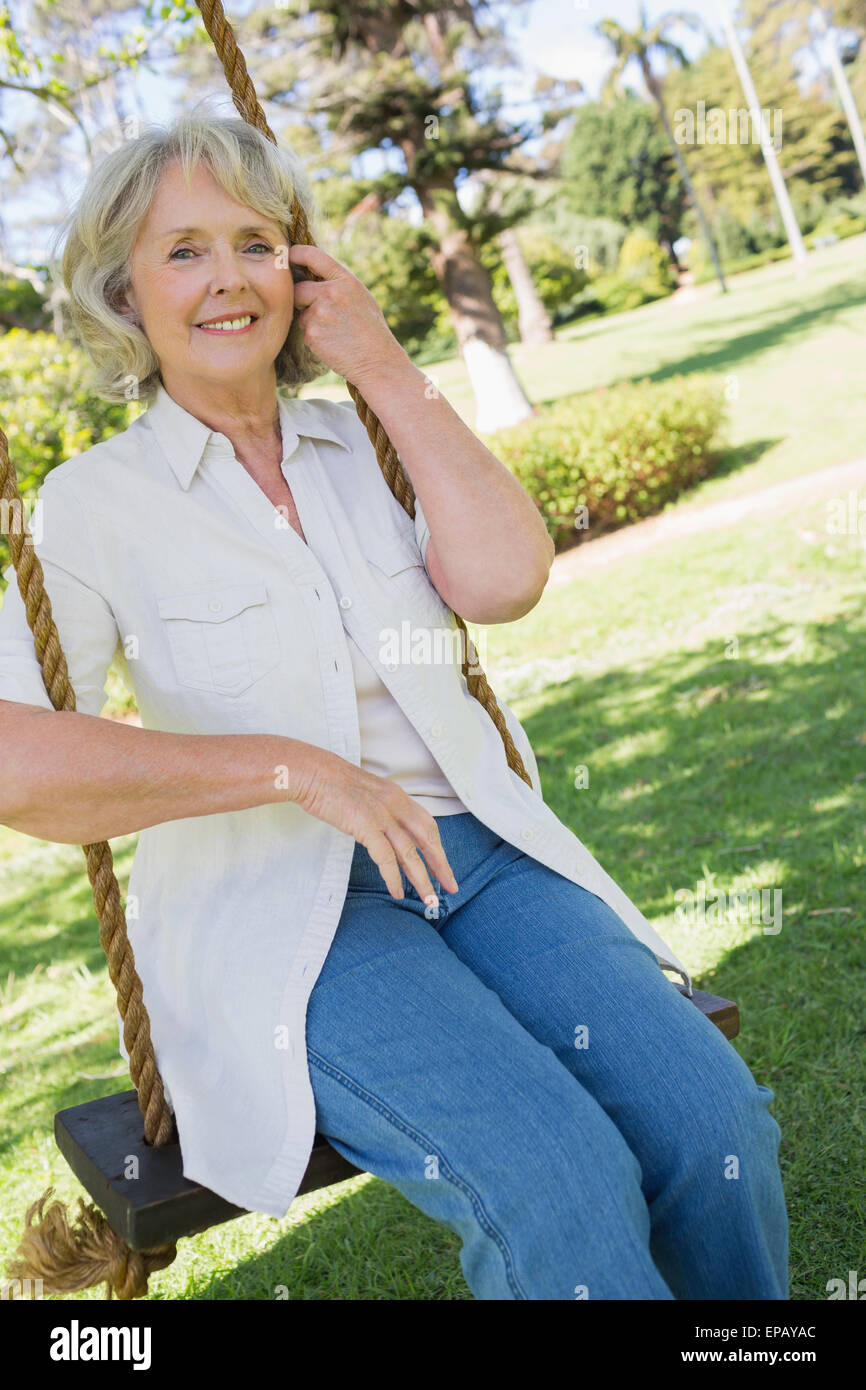 Mature woman sitting on swing hi-res stock photography and images - Alamy