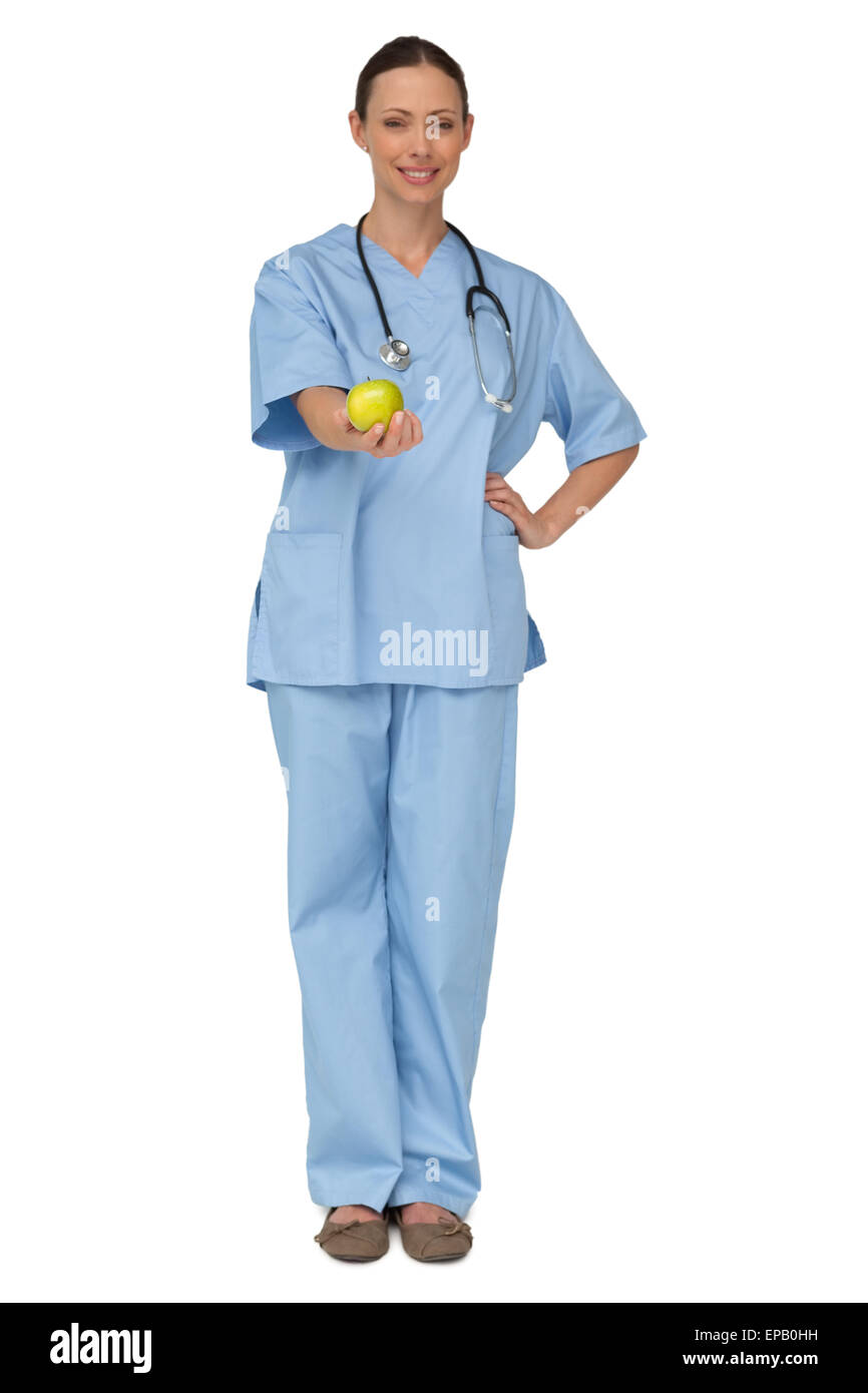 Smiling nurse in scrubs holding green apple Stock Photo Alamy