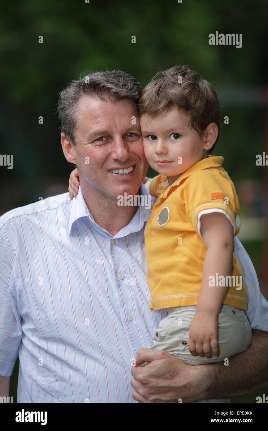 Father holding son on his arm Stock Photo