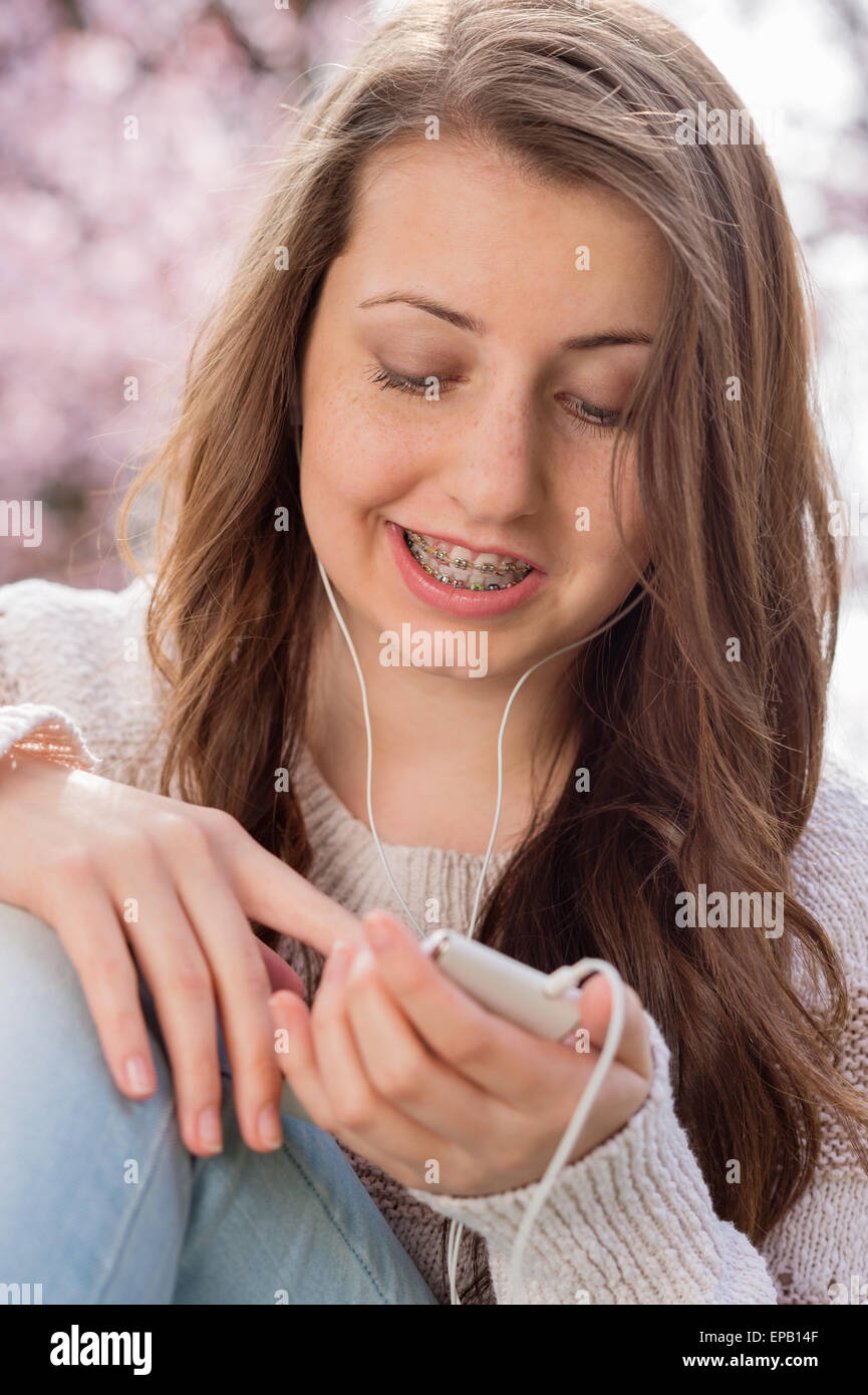 Student with braces listening to music Stock Photo Alamy