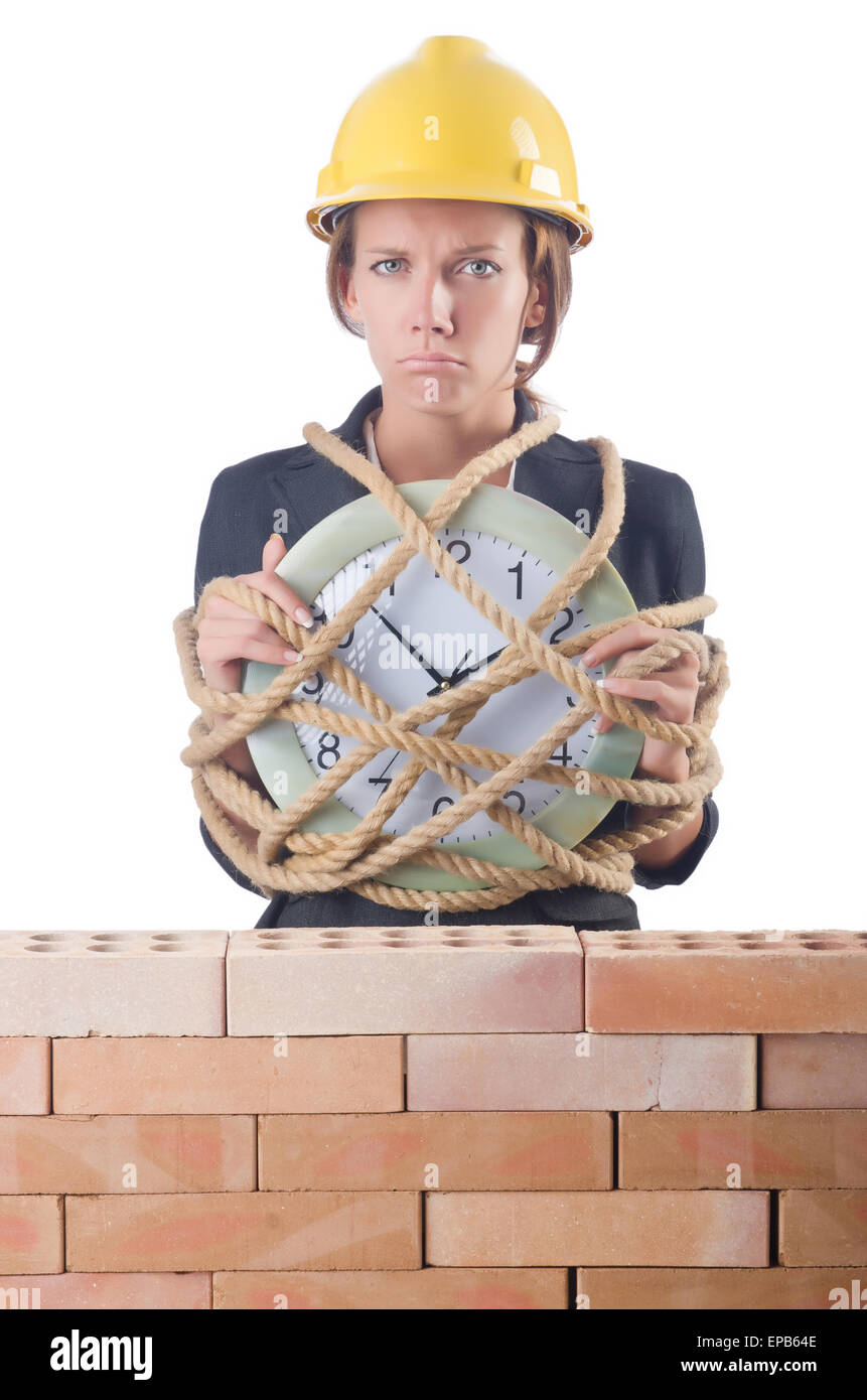 Woman construction worker with clock on white Stock Photo - Alamy