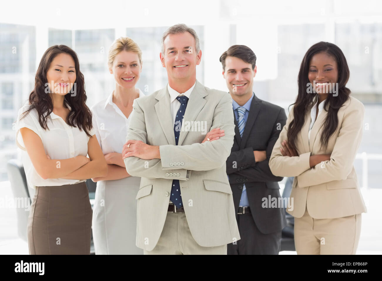 Business team smiling at camera with arms folded Stock Photo - Alamy