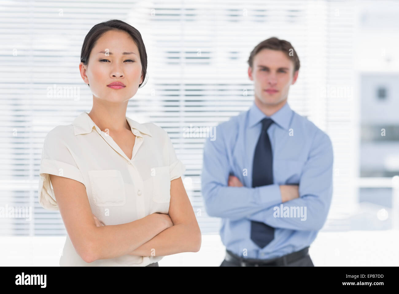 Business colleagues with arms crossed in office Stock Photo - Alamy