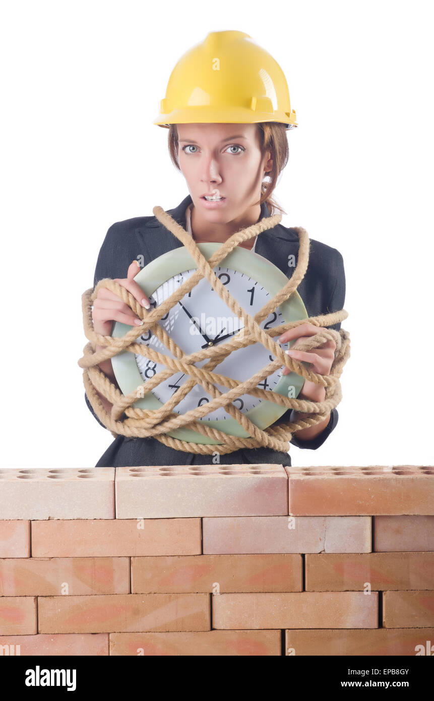 Woman construction worker with clock on white Stock Photo - Alamy
