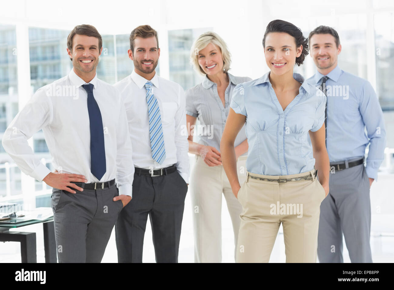 Confident smiling business team in office Stock Photo - Alamy