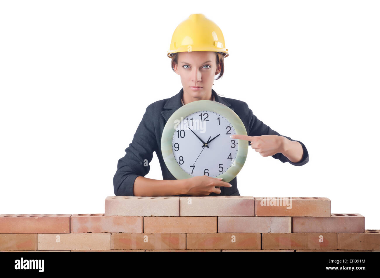 Woman construction worker with clock on white Stock Photo - Alamy