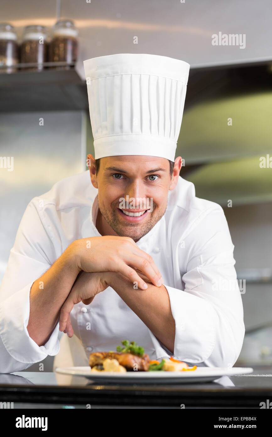 Smiling male chef with cooked food in kitchen Stock Photo - Alamy