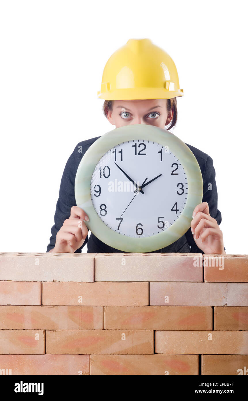 Woman construction worker with clock on white Stock Photo - Alamy