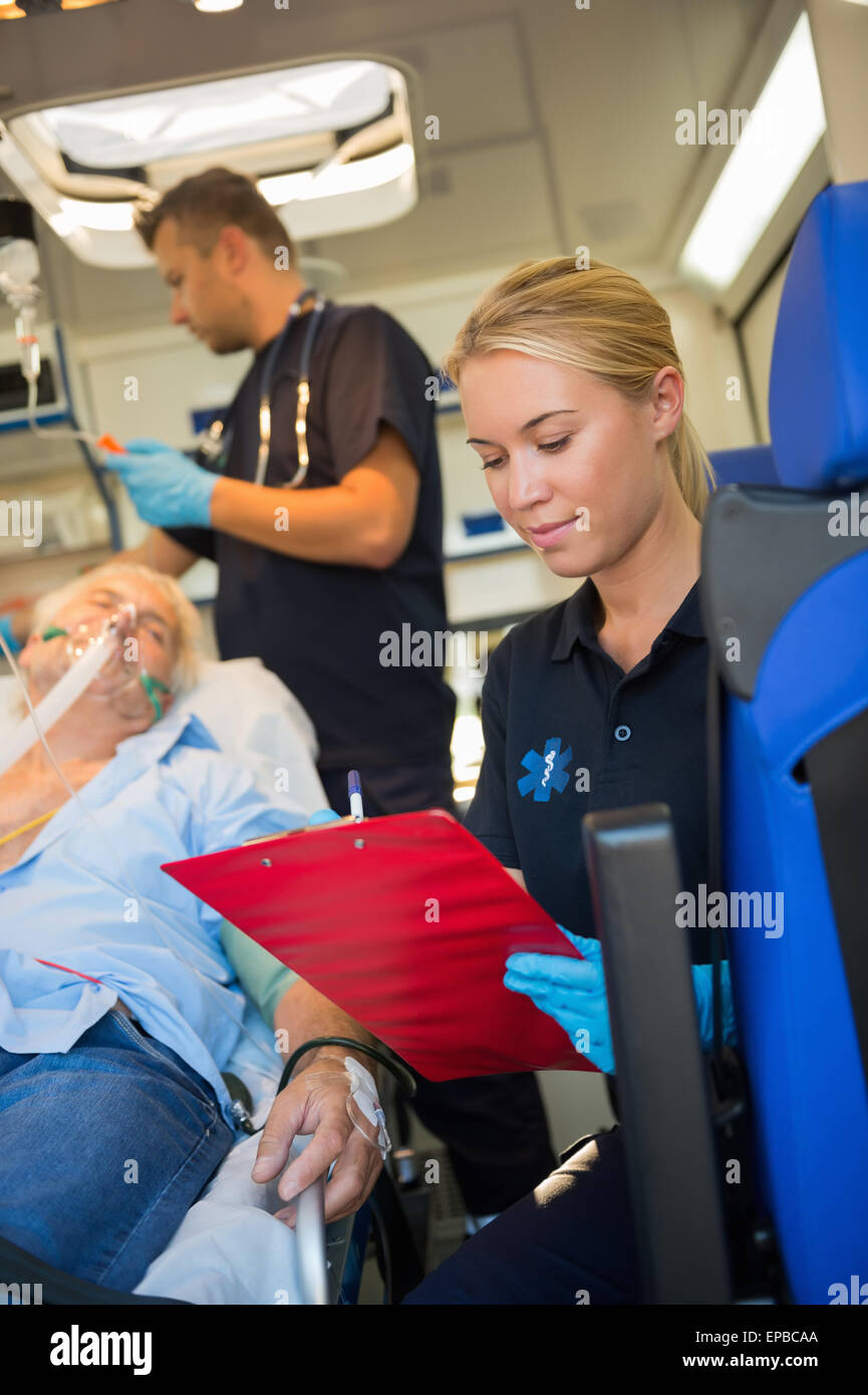 Paramedic assisting injured patient in ambulance Stock Photo
