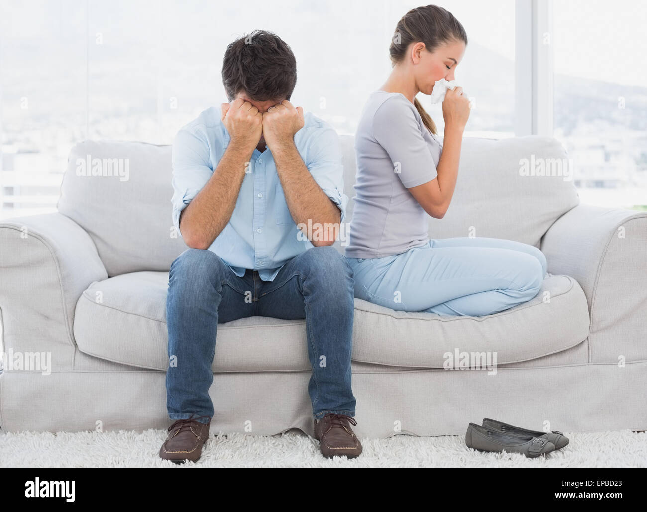 Couple on the couch after an argument Stock Photo - Alamy