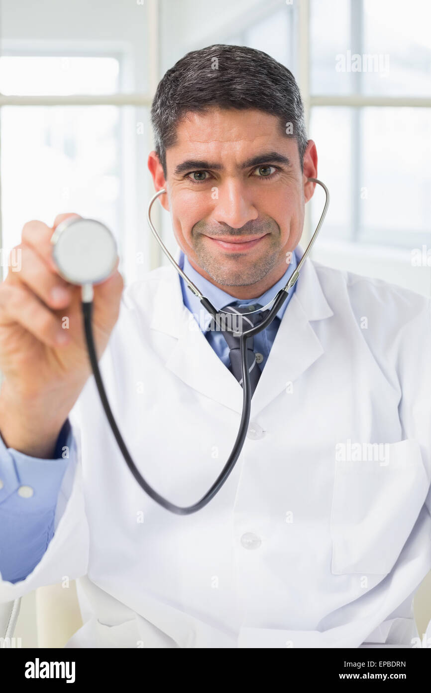 Confidence male doctor holding stethoscope Stock Photo - Alamy