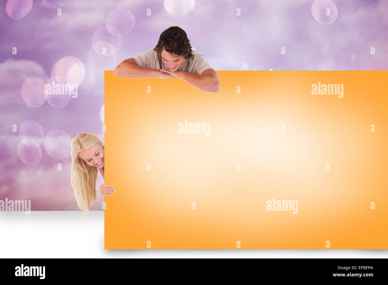 Composite image of attractive couple showing card Stock Photo - Alamy