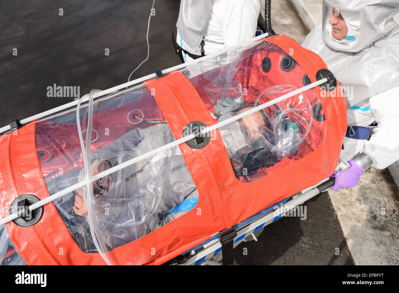 Biohazard team with virus patient in stretcher Stock Photo