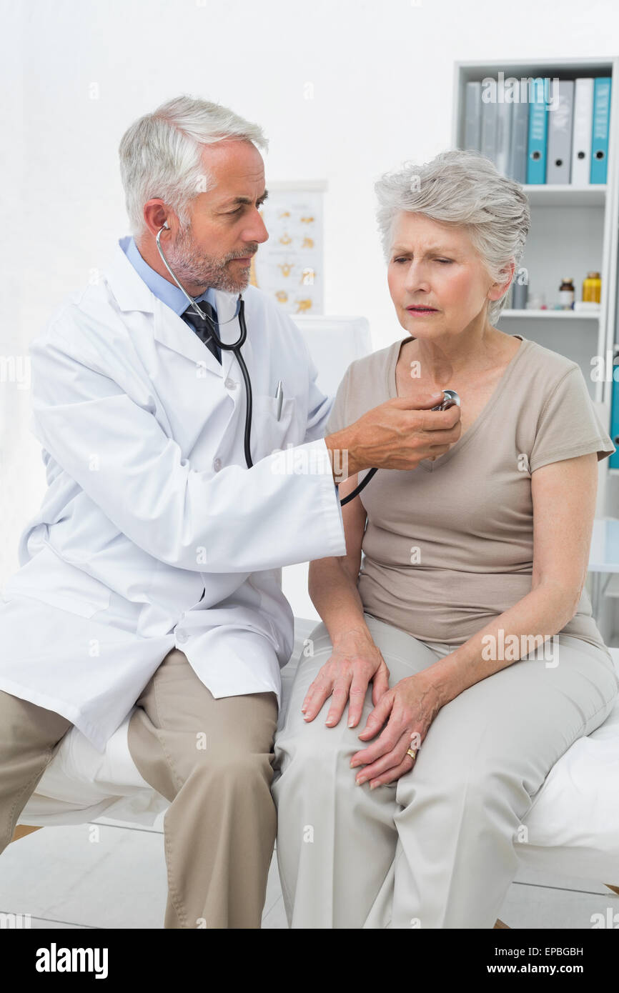 Doctor checking patients heartbeat using stethoscope Stock Photo Alamy