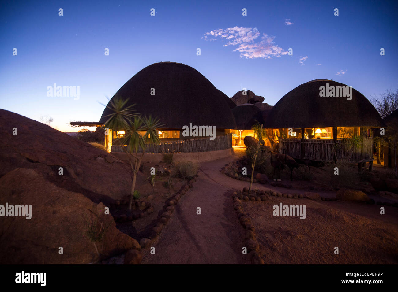 Africa, Namibia. Twilight at Mowani Mountain Camp. Gathering facilities well lit. Stock Photo