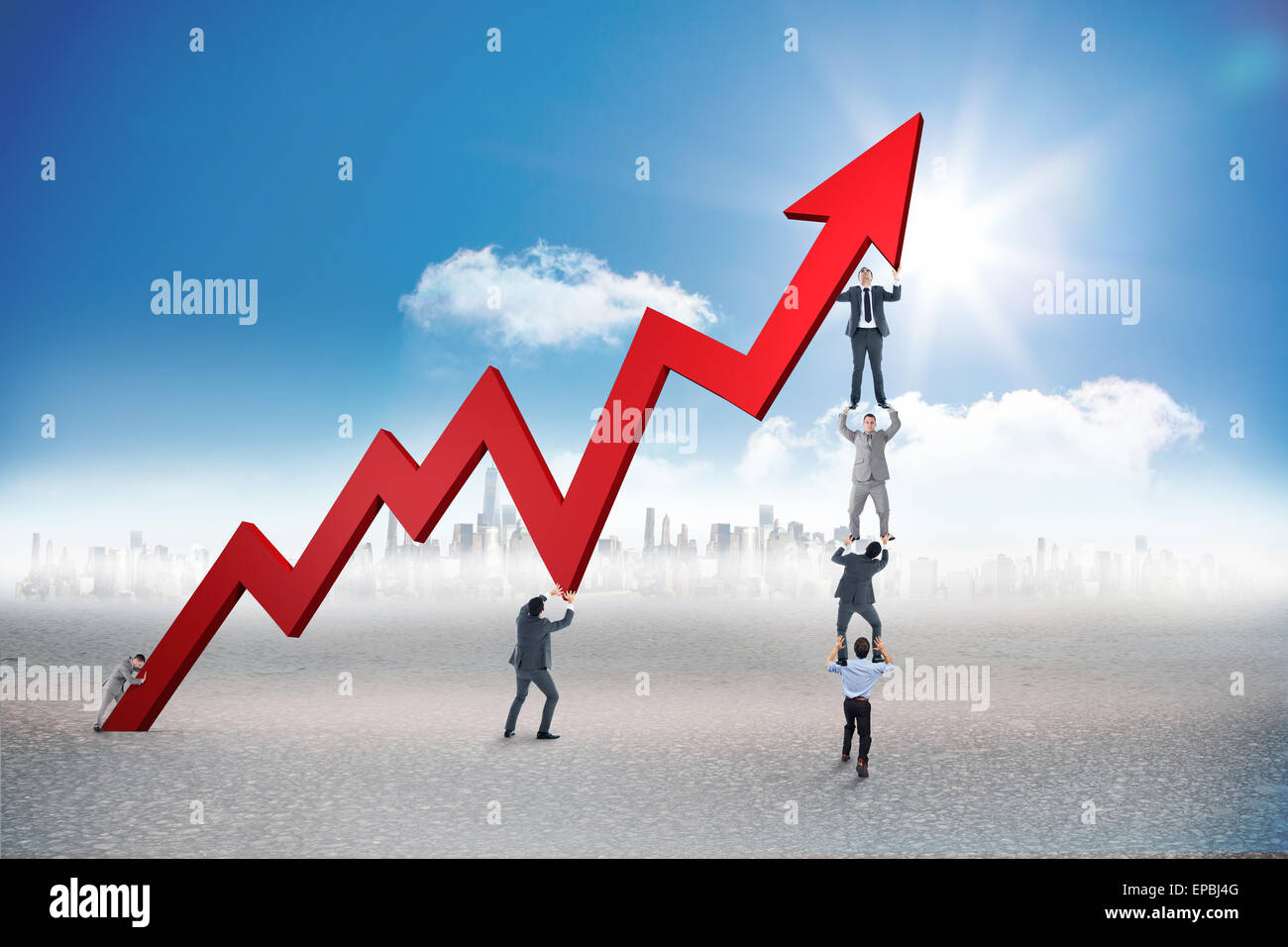 Business team holding up arrow against grey room Stock Photo - Alamy