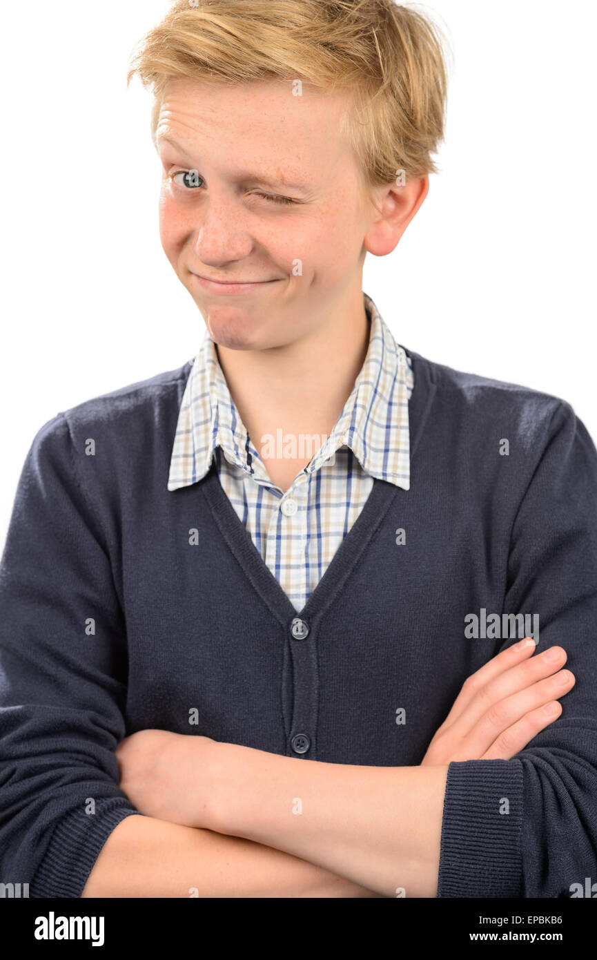 Playful boy winking while standing arms crossed Stock Photo