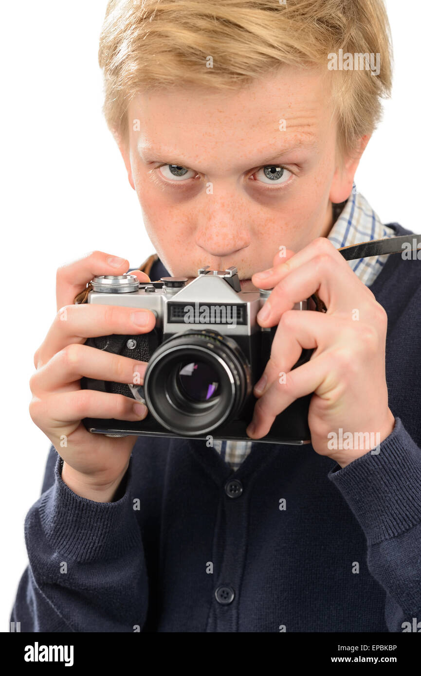 Suspicious boy photographing through retro camera Stock Photo