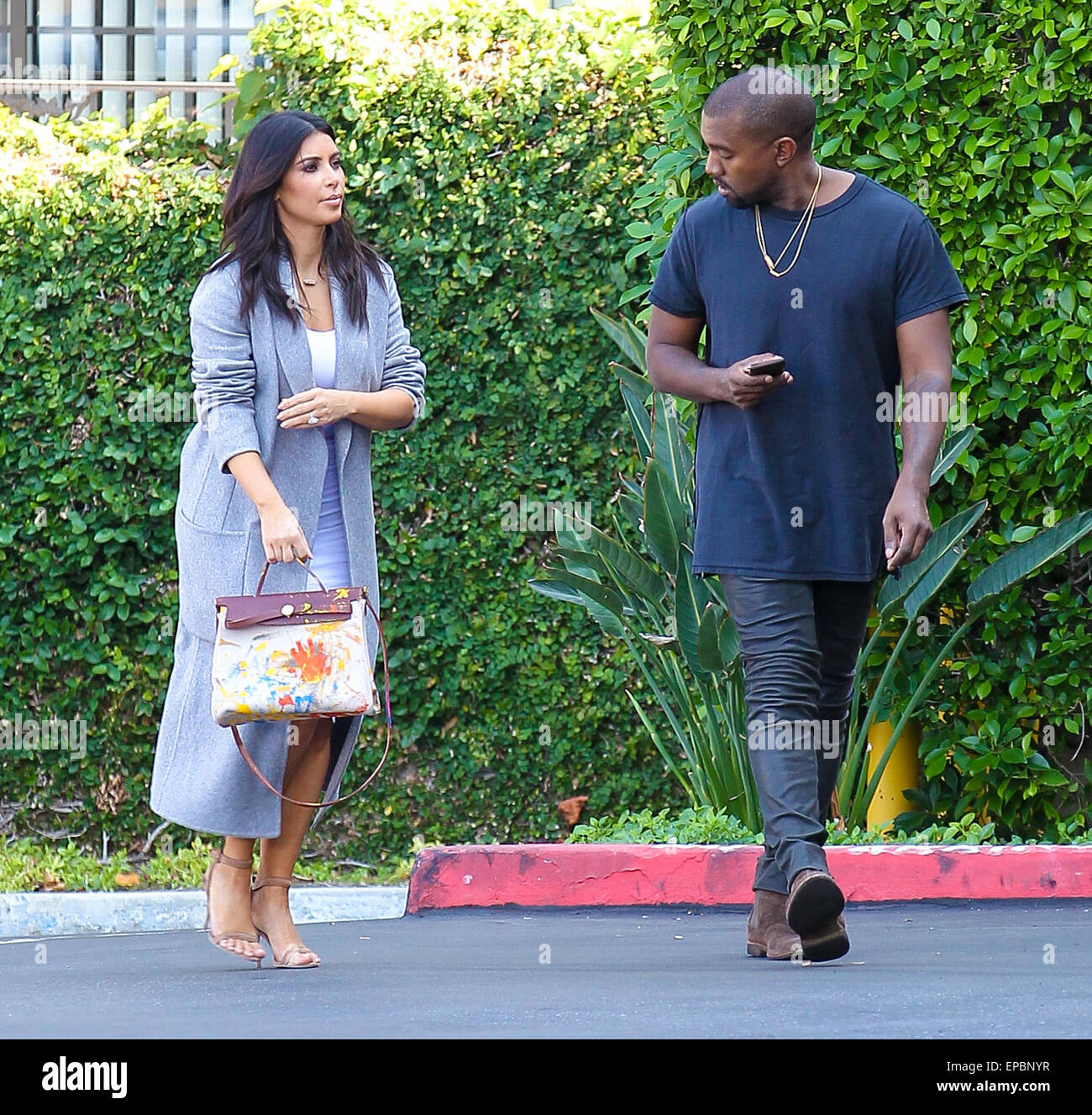 Kanye West and Kim Kardashian, who's holding an original Hermes bag painted  by their daughter North, head to the Kardashians' office in Los Angeles  Featuring: Kanye West, Kim Kardashian Where: Los Angeles