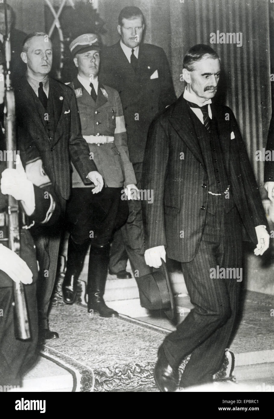 NEVILLE CHAMBERLAIN (1869-1940) leaving the Dresden Hotel, Bad Godesberg on 24 September 1938 after his meeting with Hitler. German Foreign Minister Joachim von Ribbentrop at left  is at left. Stock Photo