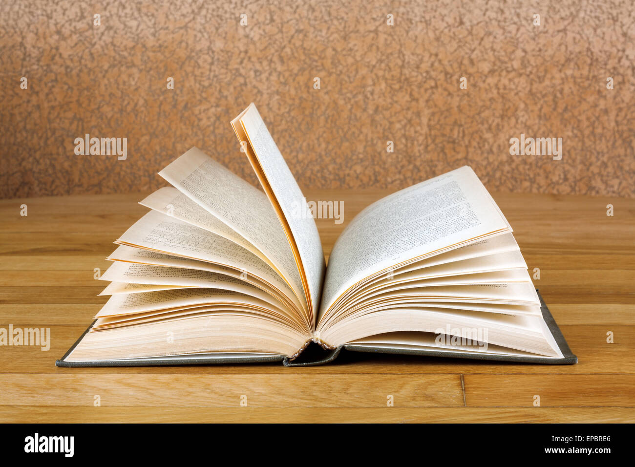 Old open book on grunge wooden table Stock Photo