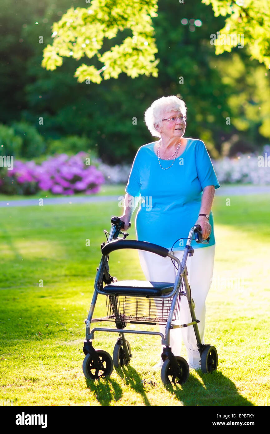 Old lady with walking frame hi-res stock photography and images - Alamy