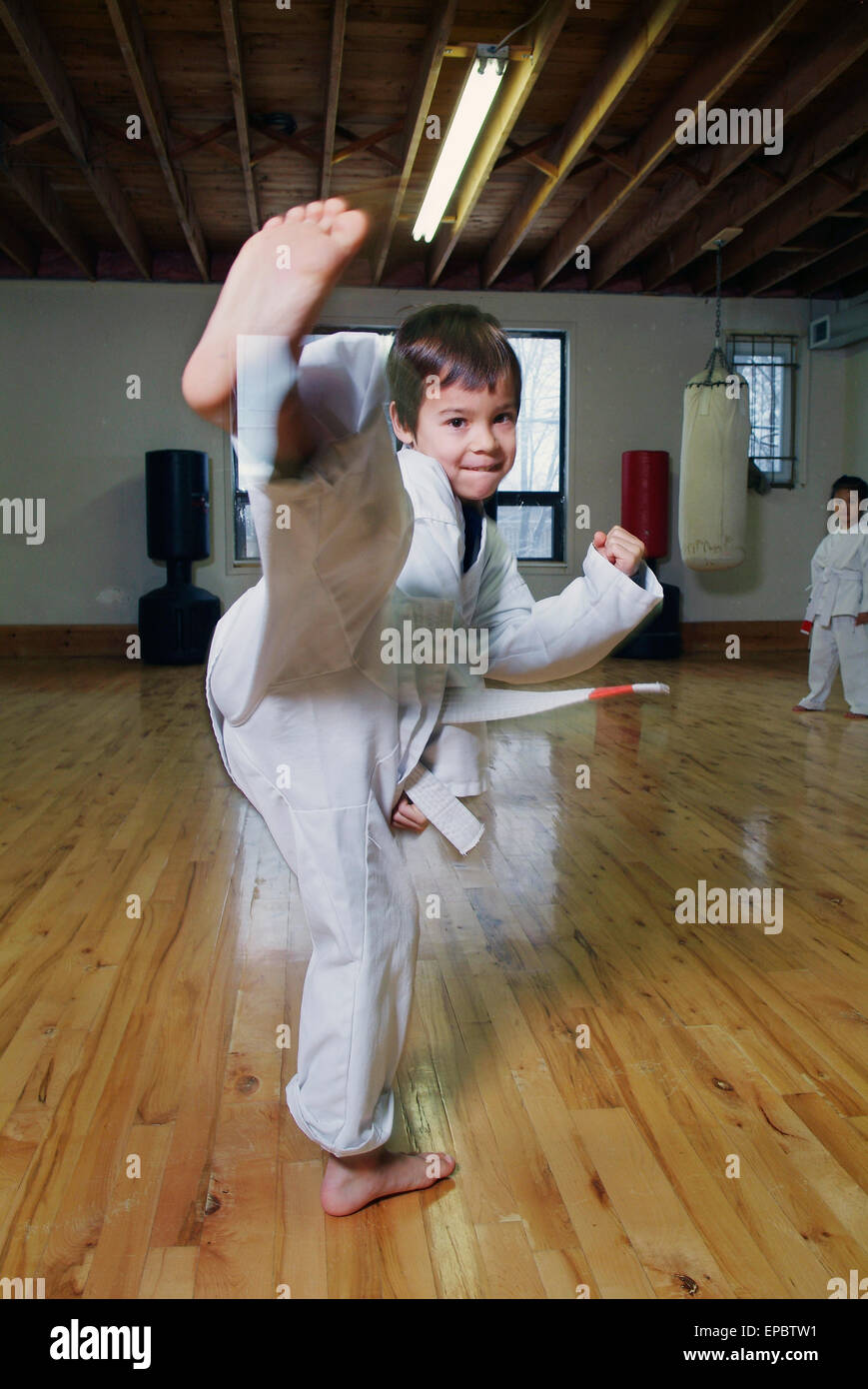 Boy in karate class demonstrating kick Stock Photo Alamy