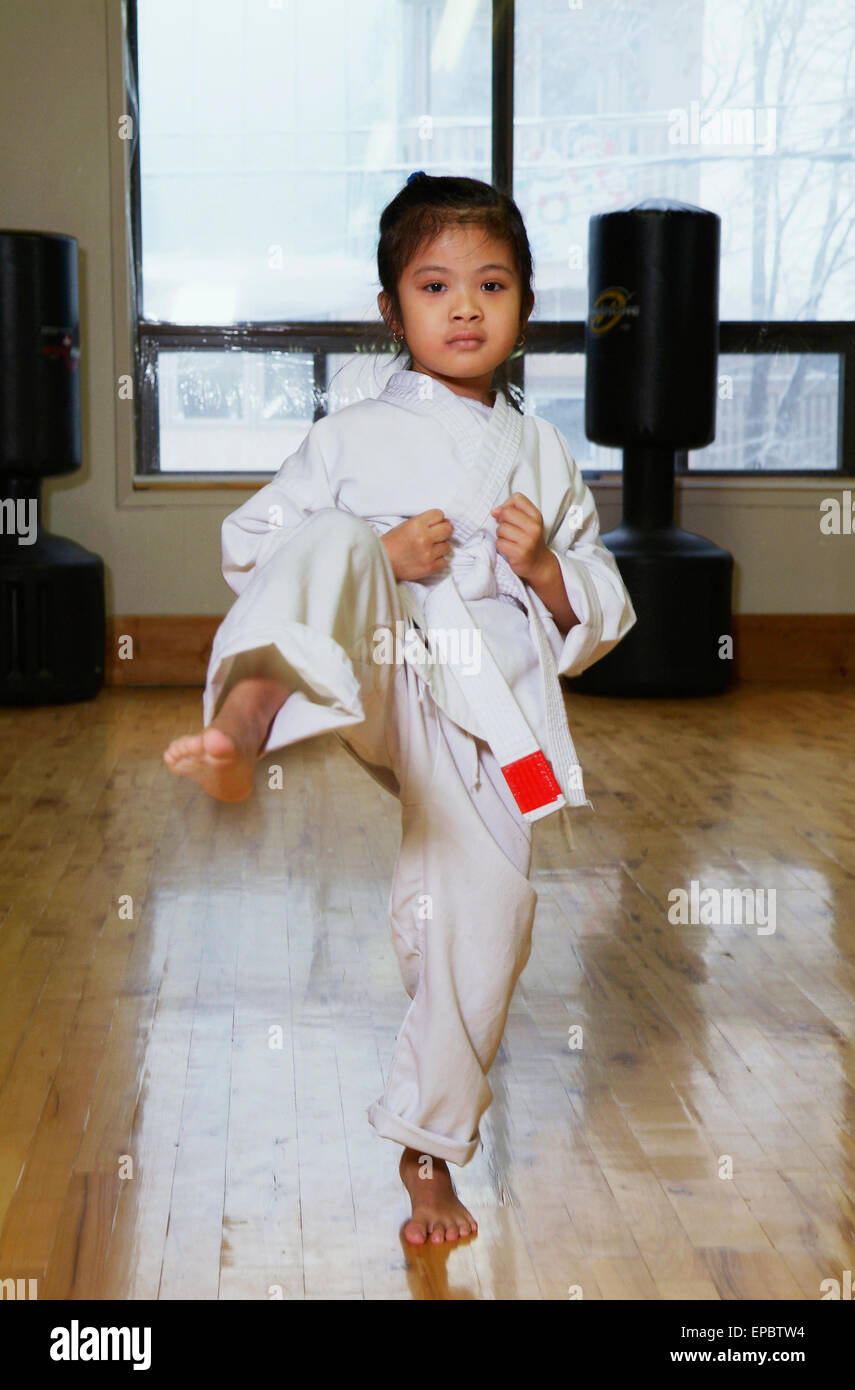 Girl in karate class demonstrating kick Stock Photo