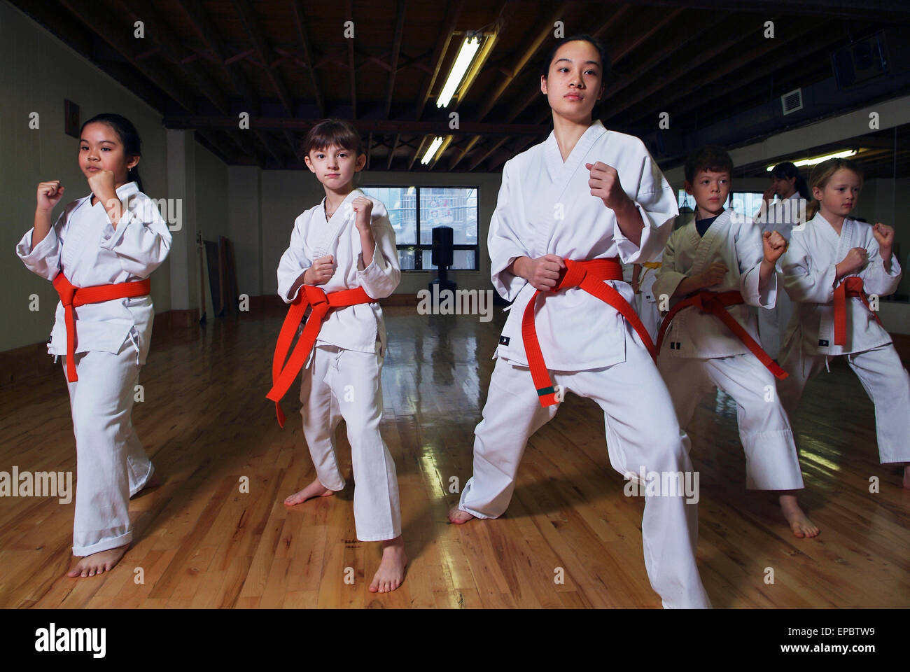 Kids demonstrating moves in karate class Stock Photo