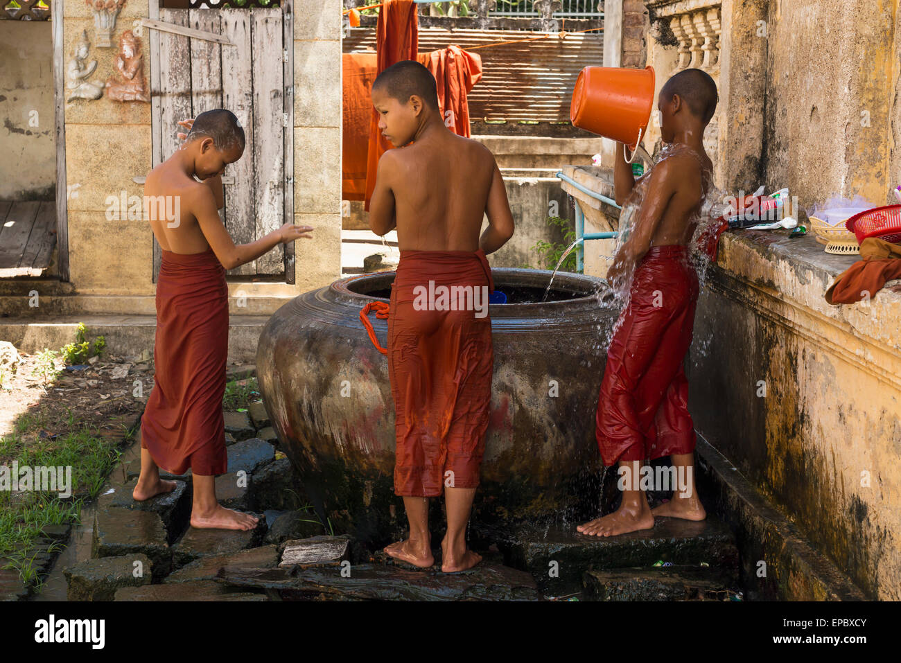 Young monks taking a shower in Wat Slaketh; Battambang, Cambodia Stock Photo