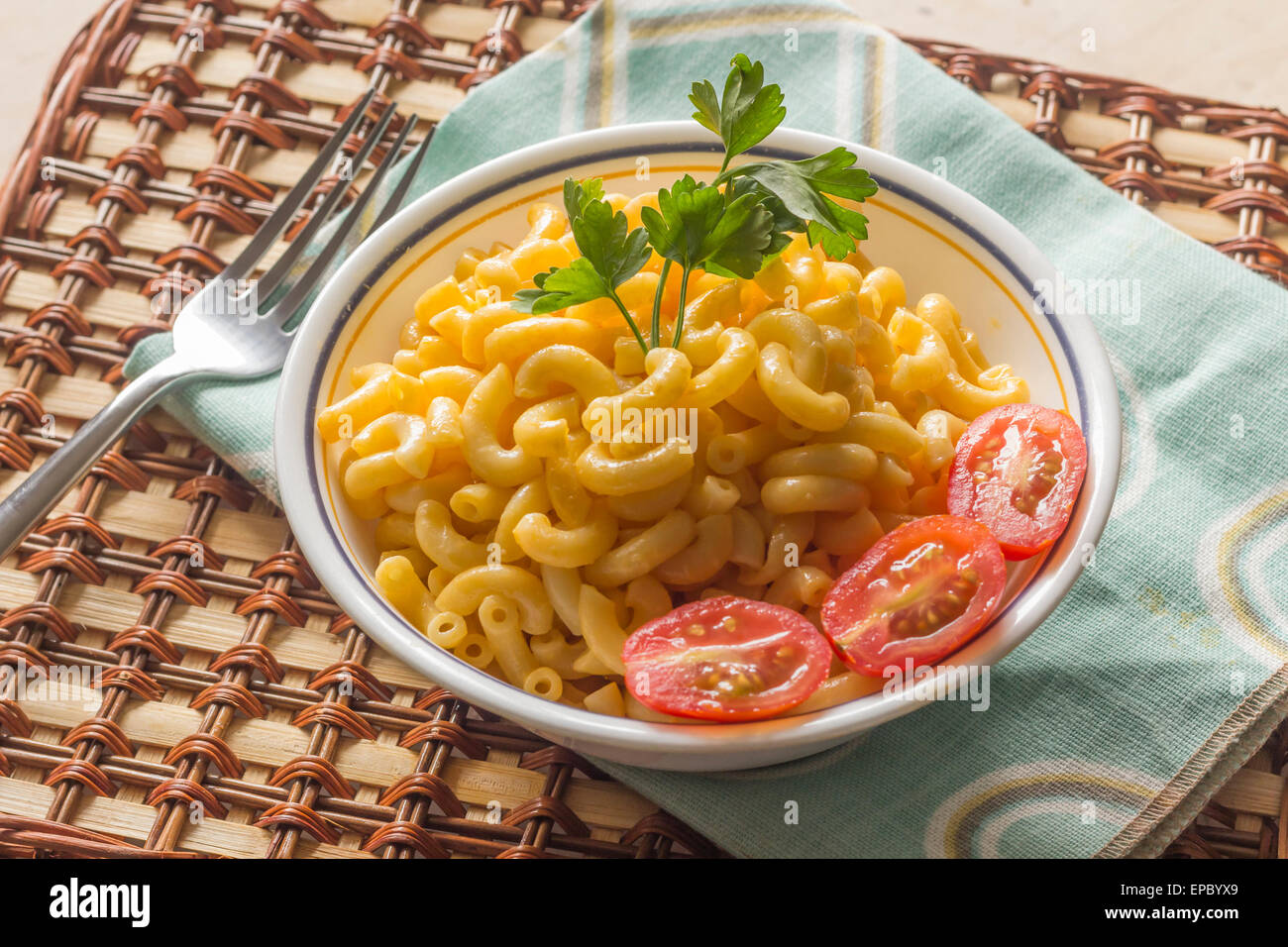 Delicious macaroni and cheddar cheese with fresh sliced grape tomatoes