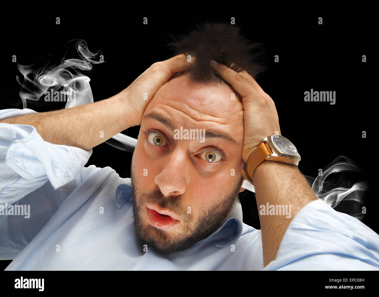 Stressed businessman with smoke coming out of his ears on white. Stock Photo