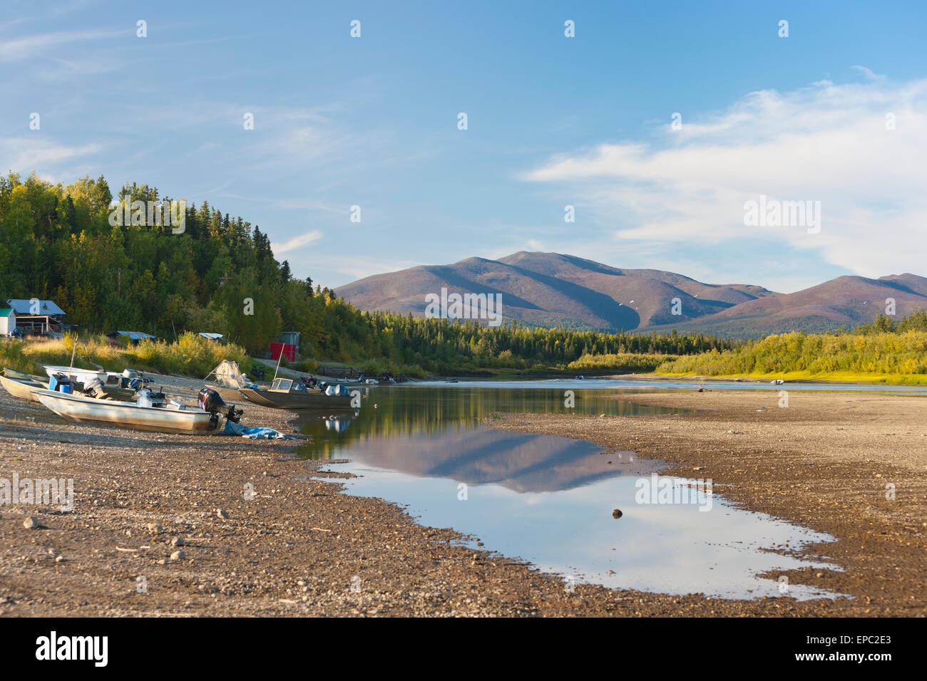 Motor boats moored on a beach along the Kobuk river, Shungnak, Arctic Alaska, summer Stock Photo