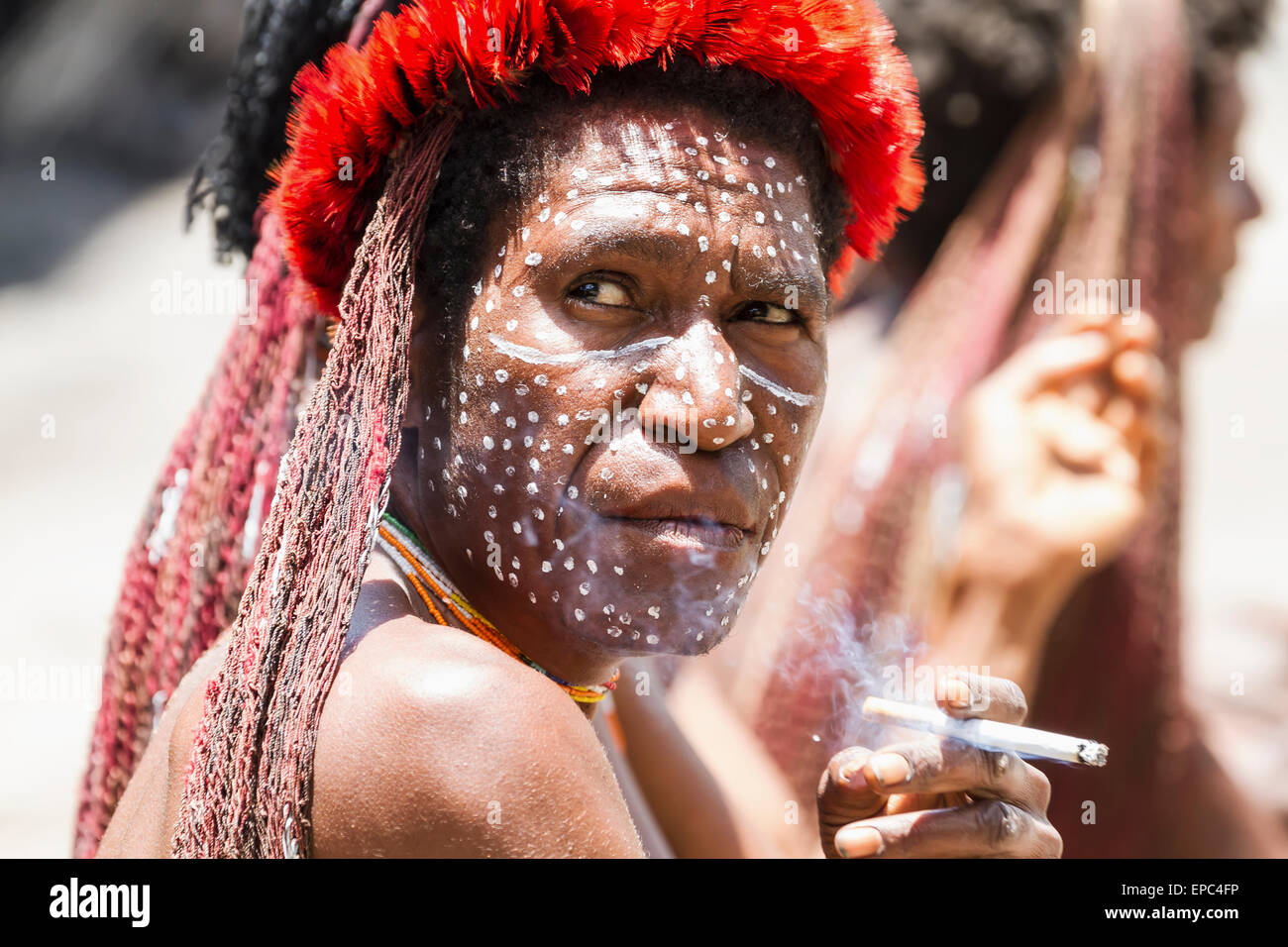 Dani woman smoking a cigarette, Obia Village, Baliem Valley, Central