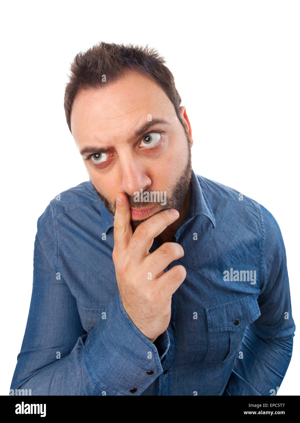 Young man with thoughtful expression on white background. Stock Photo