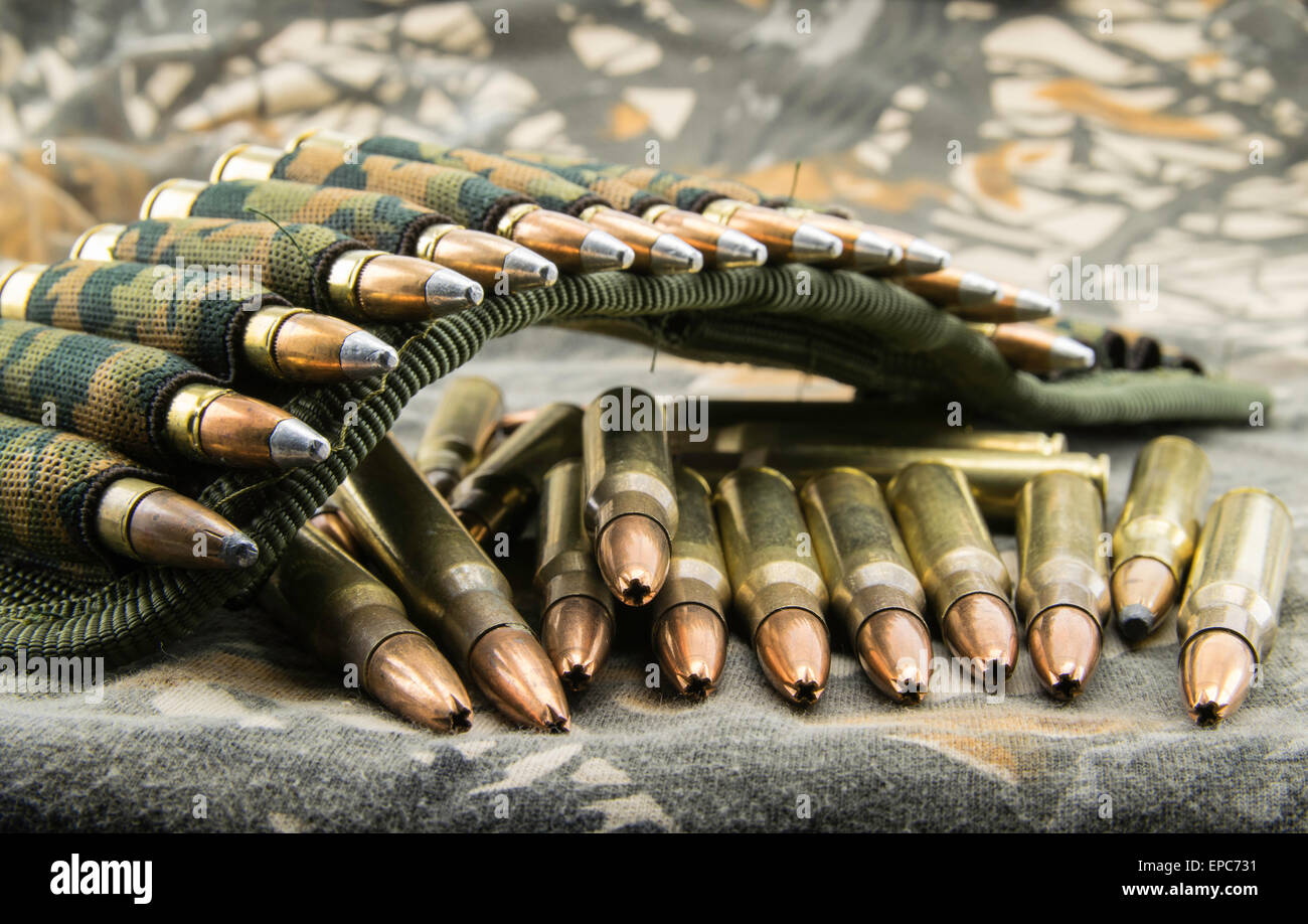 camouflage ammunition belt for rifle  on camouflage background Stock Photo