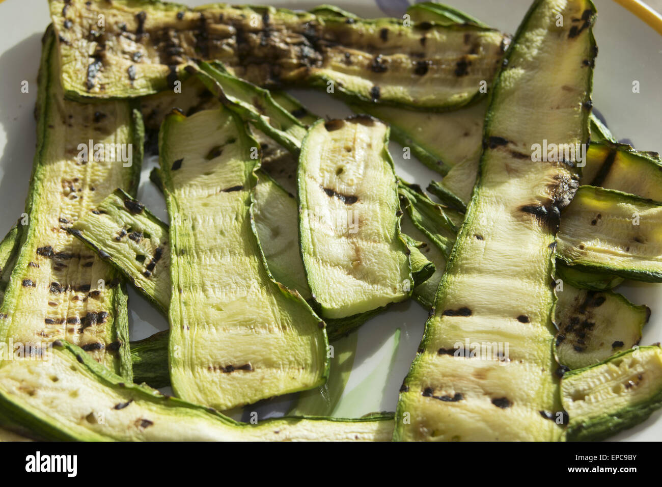 roasted zucchini at the griddle ready to be dressed Stock Photo