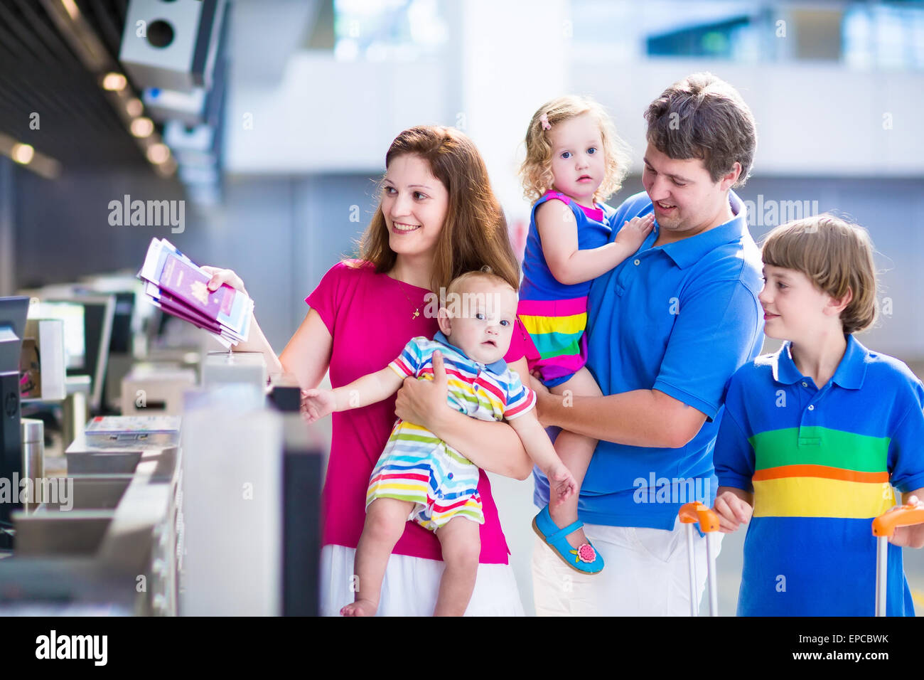 Big happy family with three kids traveling by airplane at Dusseldorf International airport, parents with children Stock Photo