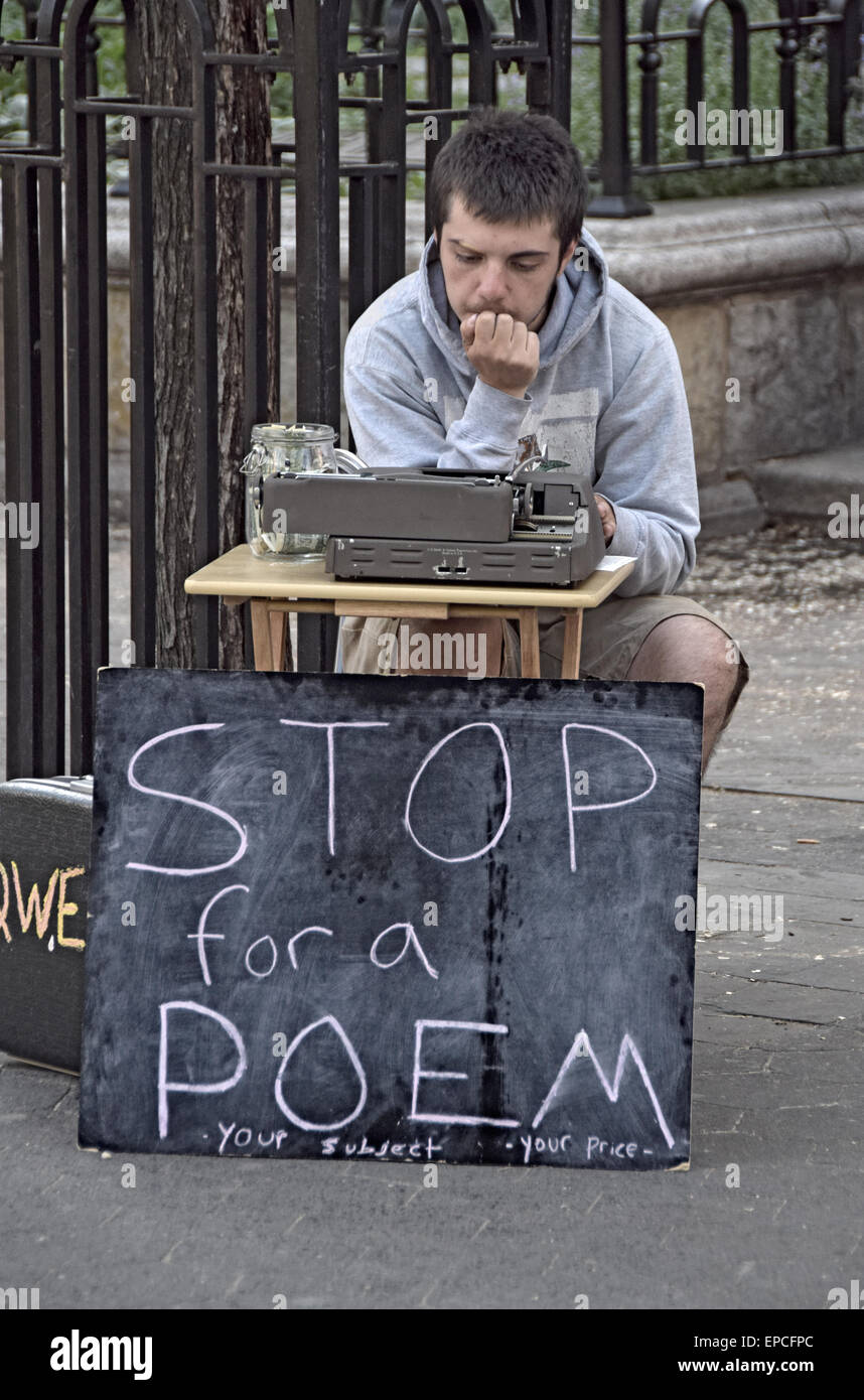 An poet and street busker soliciting money for writing poems in Union Square Park, New York City Stock Photo